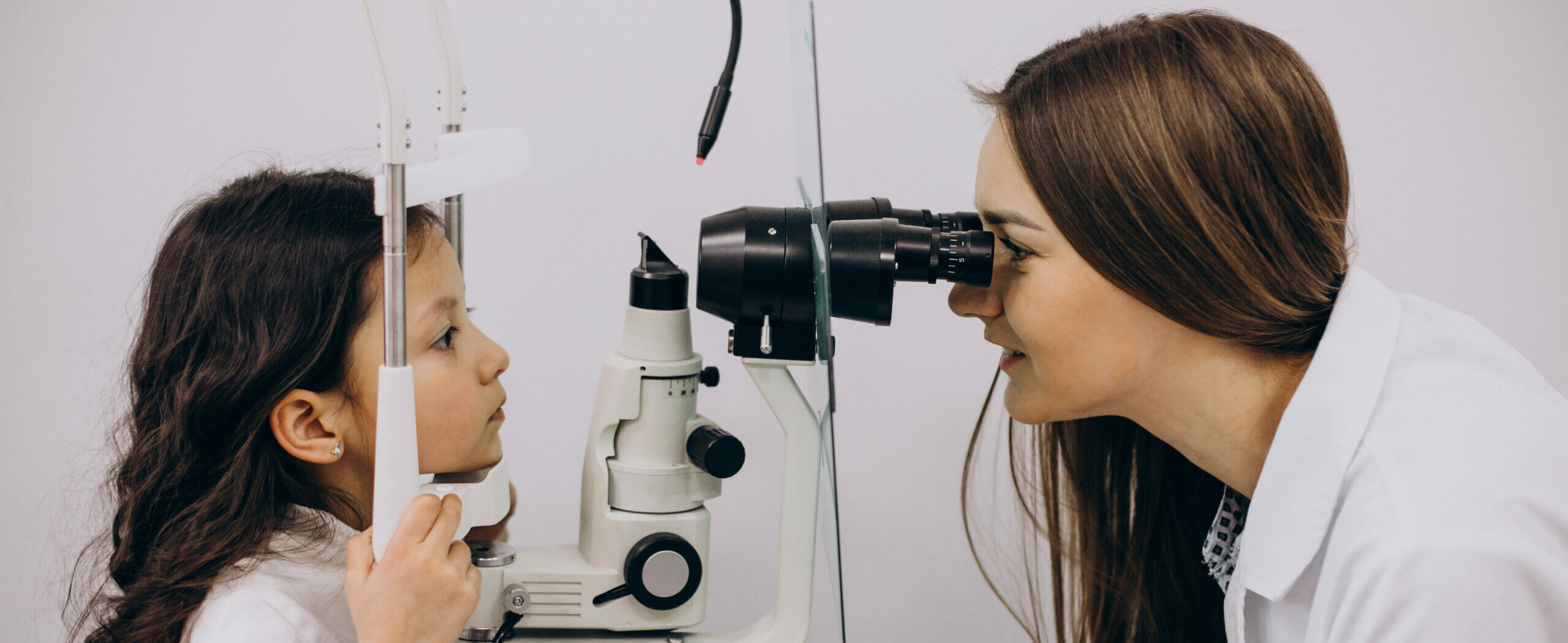 Little girl checking up her sight at ophthalmology center